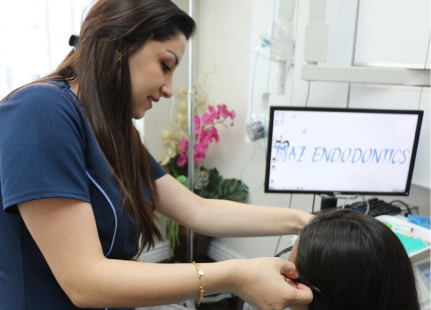 Picture of a female doctor assisting her patient to put eye glasses on